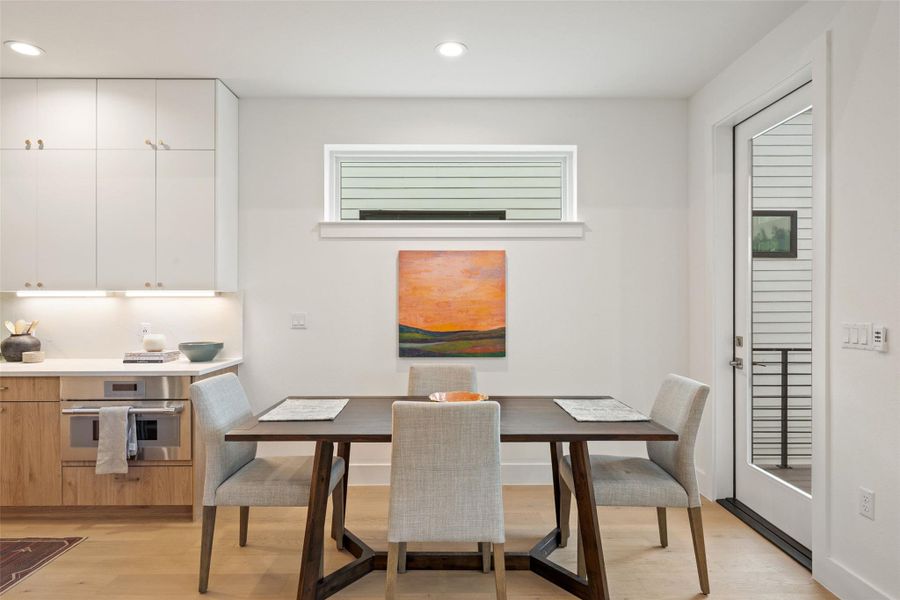A well-lit dining area and kitchen provide comfortable spaces for daily living. A well-lit dining area and kitchen provide comfortable spaces for daily living.