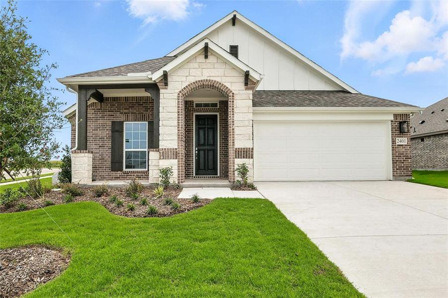 View of front facade featuring brick siding, concrete driveway, an attached garage, a front lawn, and board and batten siding