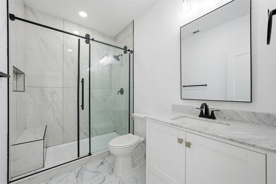 Bathroom with vanity, light marble finish floors, recessed lighting, and a marble finish shower Bathroom with vanity, light marble finish floors, recessed lighting, and a marble finish shower