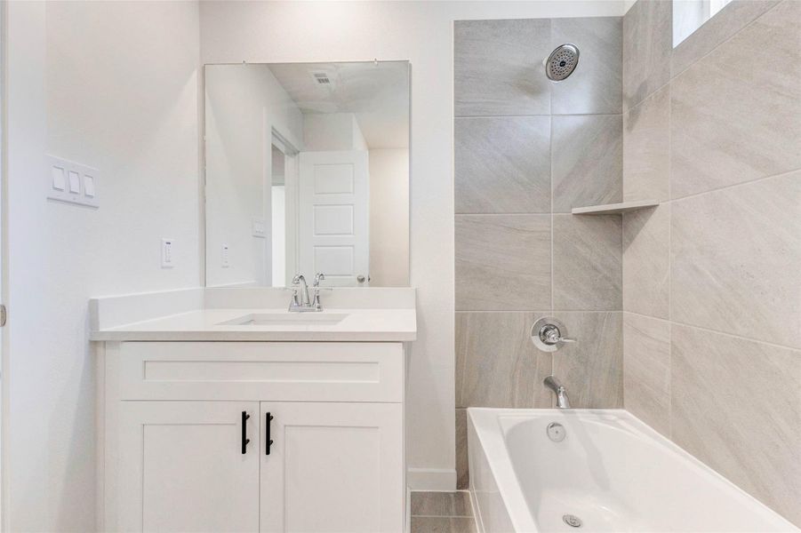 From this angle, the designer tile and minimalist finishes shine. The built-in shower niche offers function without sacrificing style, while the single-sink vanity and wide mirror provide ample space for daily routines with a polished, upscale look. From this angle, the designer tile and minimalist finishes shine. The built-in shower niche offers function without sacrificing style, while the single-sink vanity and wide mirror provide ample space for daily routines with a polished, upscale look.