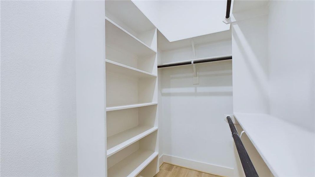 The closet provides ample double-hanging space, featuring two built-in shoe storage racks and additional long-hanging space for added convenience.