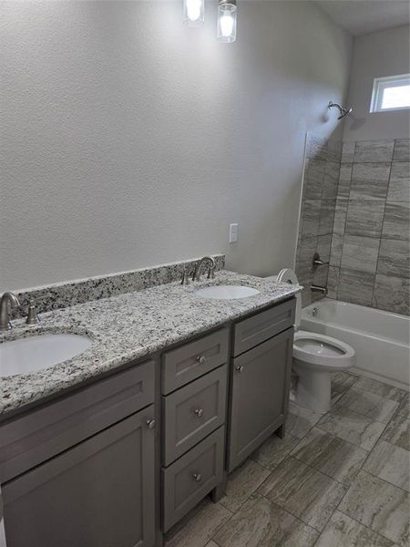 Full bathroom featuring dual vanity, tile flooring, shower / washtub combination, and toilet