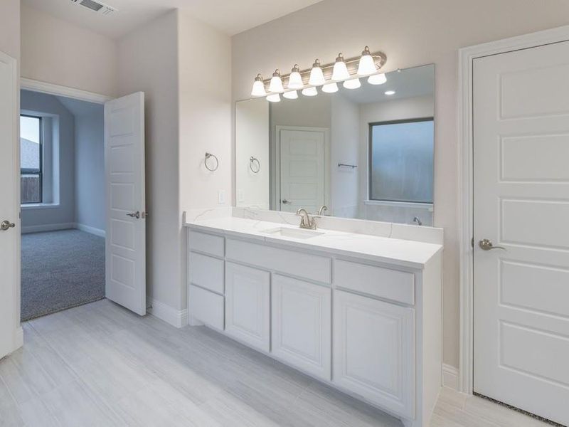 Bathroom with vanity and hardwood / wood-style flooring