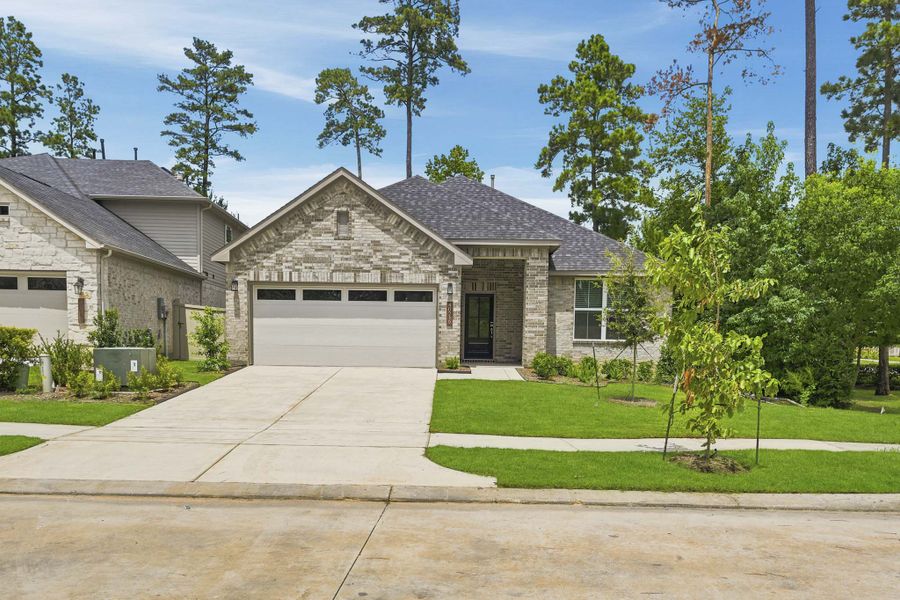 Front exterior of a new home in Audubon, Magnolia, TX, highlighting curb appeal (Image 1). Front exterior of a new home in Audubon, Magnolia, TX, highlighting curb appeal (Image 1).