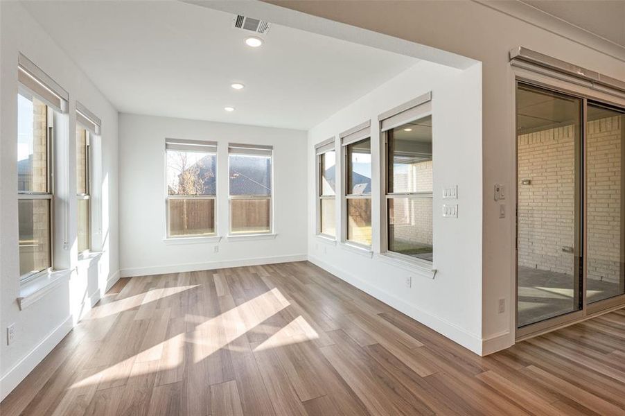 Dining sunroom featuring wood finished floors, recessed lighting, and plenty of natural light Dining sunroom featuring wood finished floors, recessed lighting, and plenty of natural light