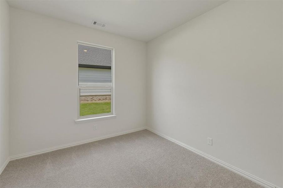 Neutral tone walls with white trim and grey carpeting