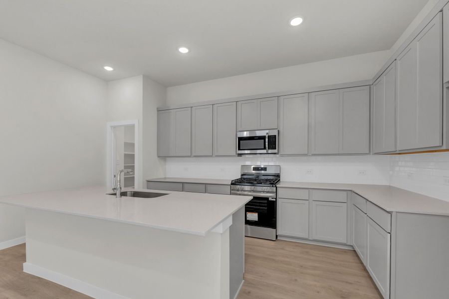 Kitchen in the Evelyn Pecos model home in Austin TX by Trophy Signature Homes