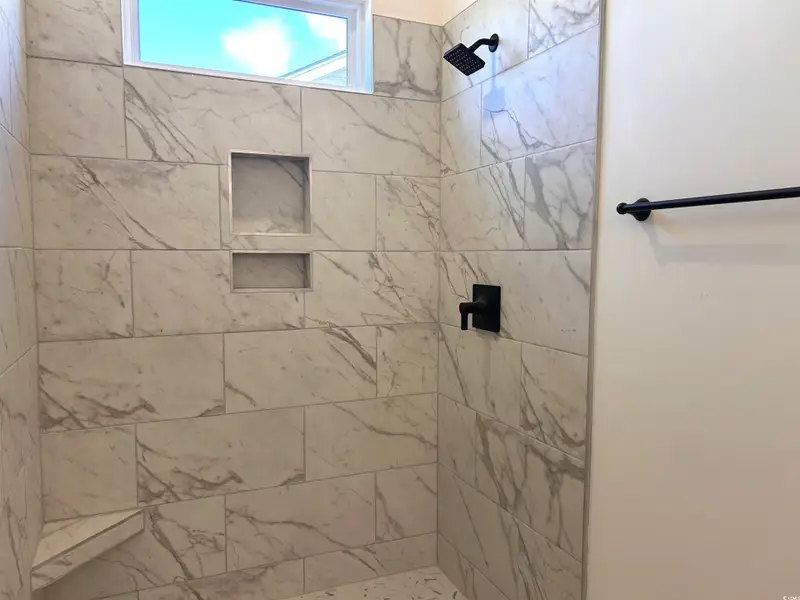 Full bathroom featuring tiled shower