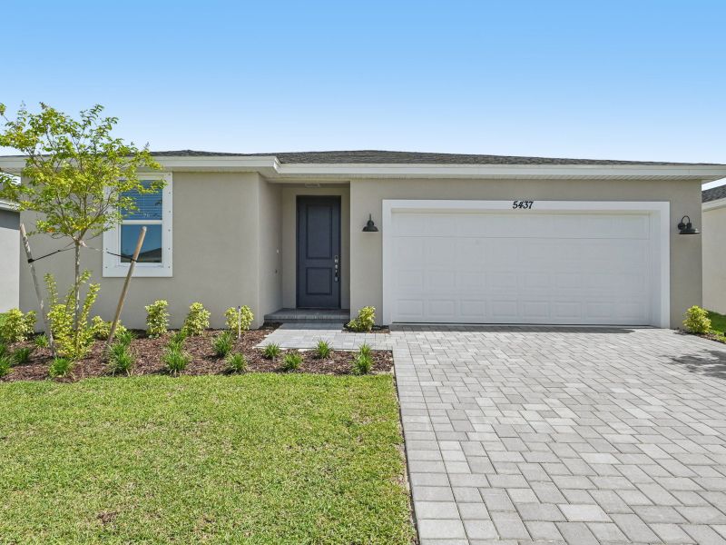 Front exterior of a new home in Hampton Park - Classic Series, Vero Beach, FL, highlighting curb appeal (Image 1). Front exterior of a new home in Hampton Park - Classic Series, Vero Beach, FL, highlighting curb appeal (Image 1).