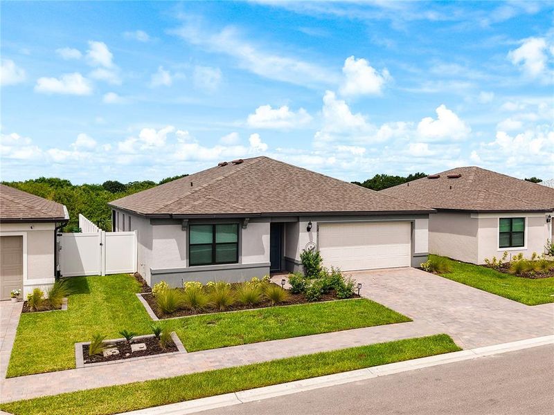 Front exterior of a new home in Caloosa Cove, Labelle, FL, highlighting curb appeal (Image 25).