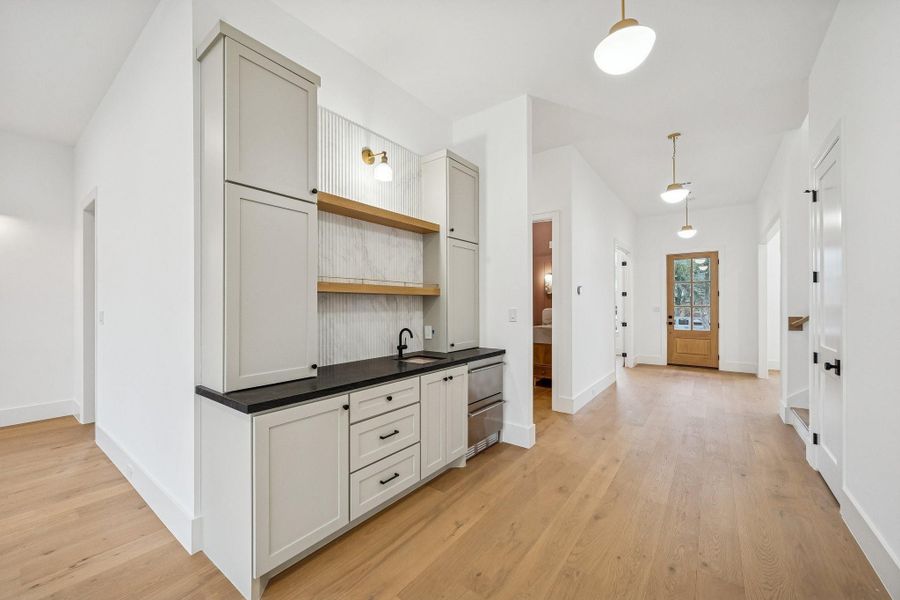 The wet bar connecting the spaces, making entertaining a breeze.