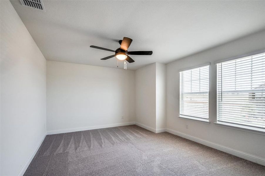Unfurnished room featuring carpet and ceiling fan Unfurnished room featuring carpet and ceiling fan