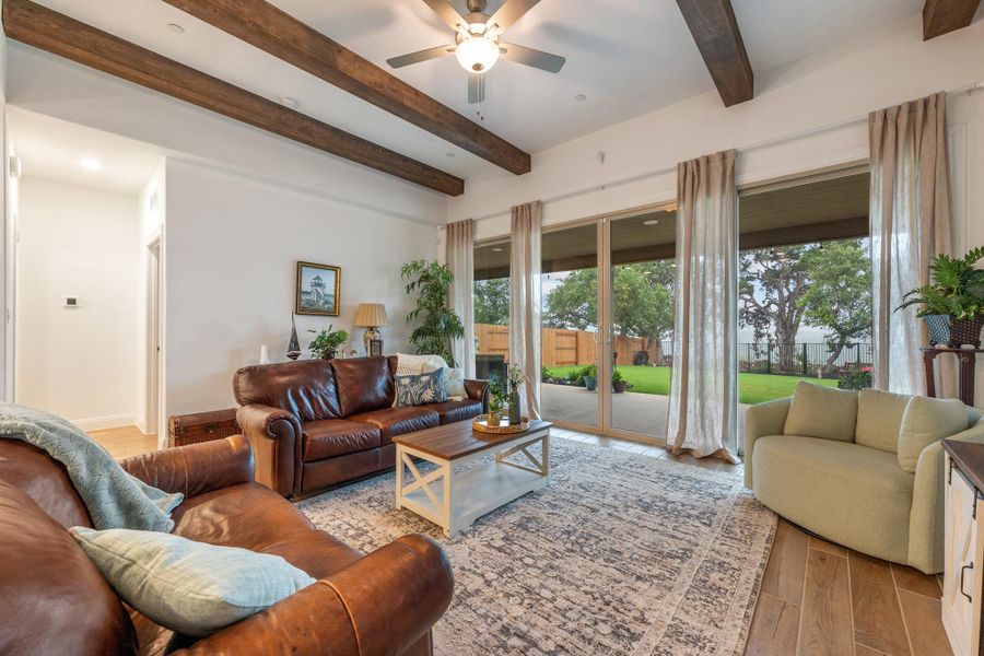 Open-concept living space with rustic wood beams and ample natural light. Open-concept living space with rustic wood beams and ample natural light.