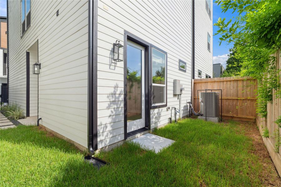 An intimate green escape bordered by warm fencing, this outdoor space blends minimal maintenance with maximum privacy.