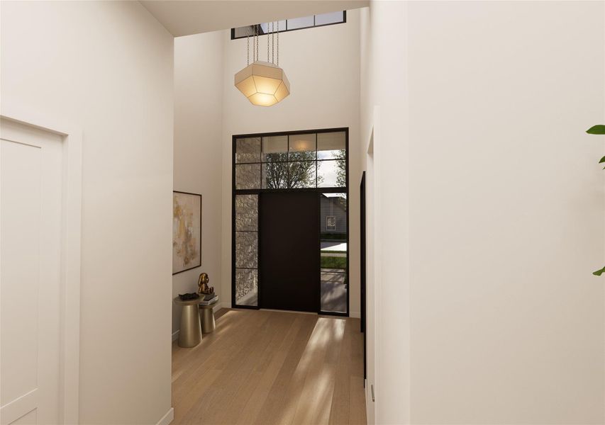 A soaring two-story foyer makes an unforgettable first impression, where steel-framed glass and sculptural lighting set a tone of quiet drama. Sunlight spills across warm oak floors, guiding you into a home designed for both statement and serenity. A soaring two-story foyer makes an unforgettable first impression, where steel-framed glass and sculptural lighting set a tone of quiet drama. Sunlight spills across warm oak floors, guiding you into a home designed for both statement and serenity.