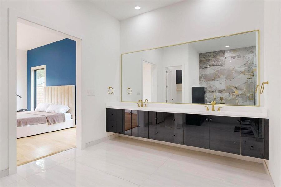 Bathroom featuring double vanity, ensuite bathroom, a marble finish shower, and recessed lighting Bathroom featuring double vanity, ensuite bathroom, a marble finish shower, and recessed lighting