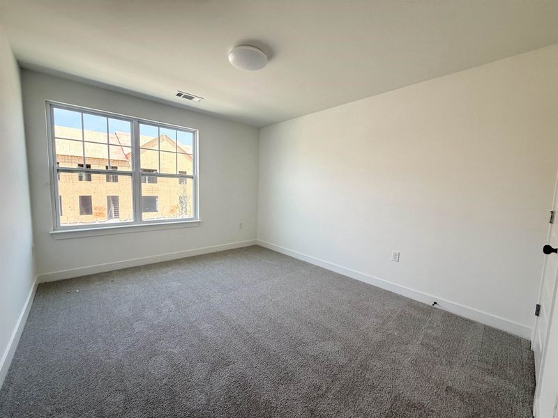 Carpeted spare room with baseboards