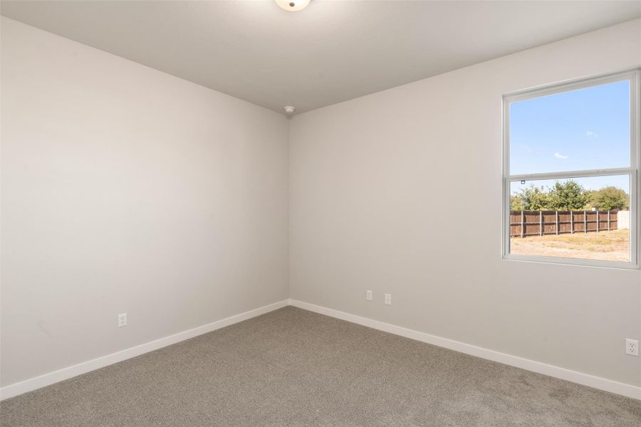 Unfurnished room with baseboards and carpet flooring Unfurnished room with baseboards and carpet flooring