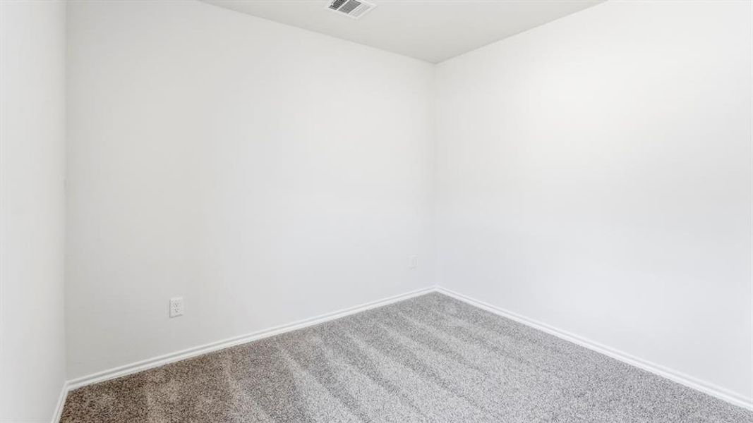 Empty room featuring carpet flooring and baseboards Empty room featuring carpet flooring and baseboards
