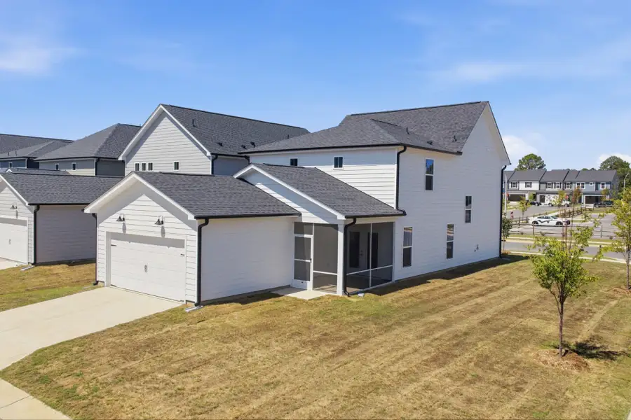 Front exterior of a new home in Saunders Farm, Willow Spring, NC, highlighting curb appeal (Image 23). Front exterior of a new home in Saunders Farm, Willow Spring, NC, highlighting curb appeal (Image 23).