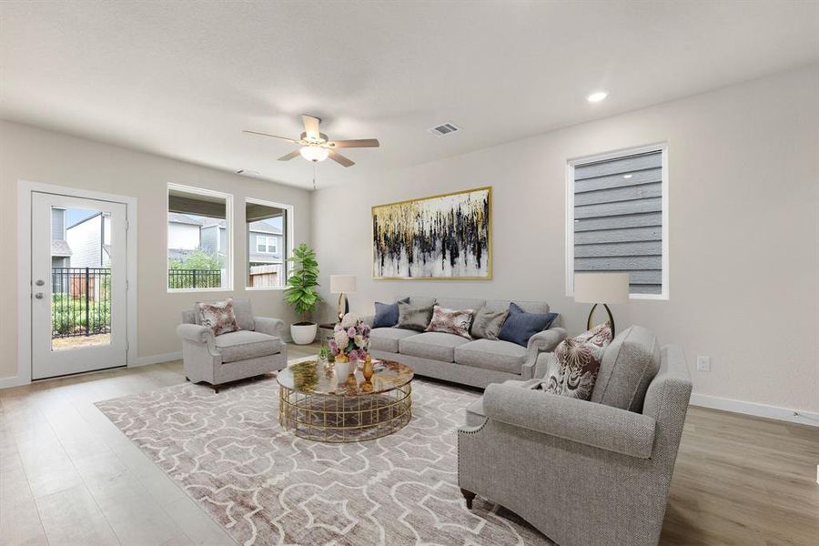 Gather the family and guests together in your lovely living room! Featuring soaring ceilings, recessed lighting,  ceiling fan, neutral paint, gorgeous EVP floors and large windows that provide plenty of natural lighting throughout the day.