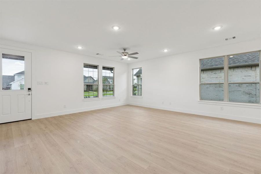 Unfurnished room featuring light wood finished floors, a ceiling fan, and recessed lighting Unfurnished room featuring light wood finished floors, a ceiling fan, and recessed lighting