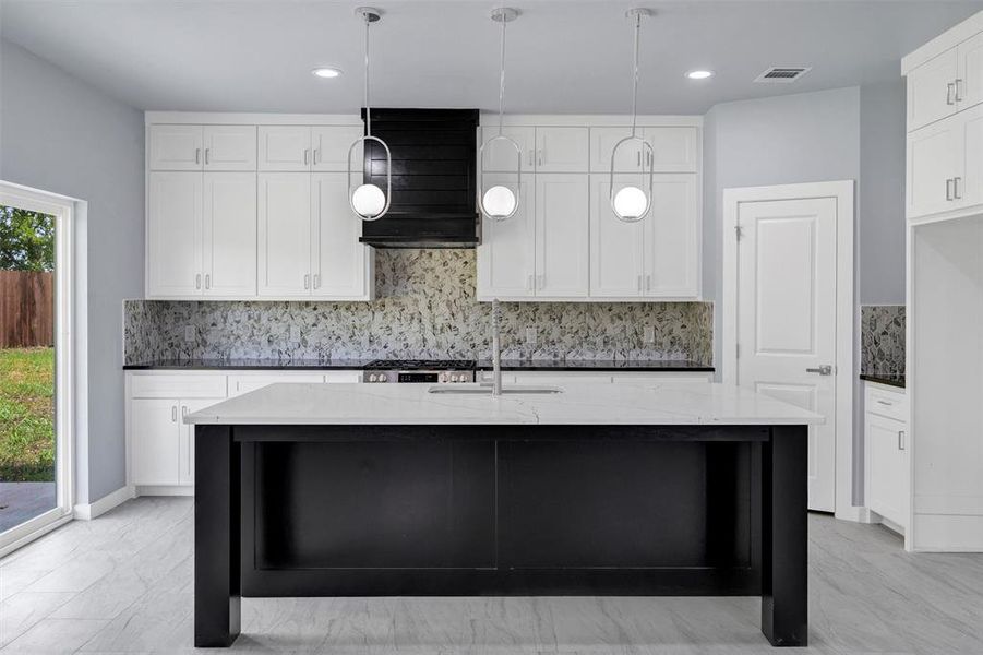 Kitchen with tasteful backsplash, dark cabinets, extractor fan, pendant lighting, and recessed lighting
