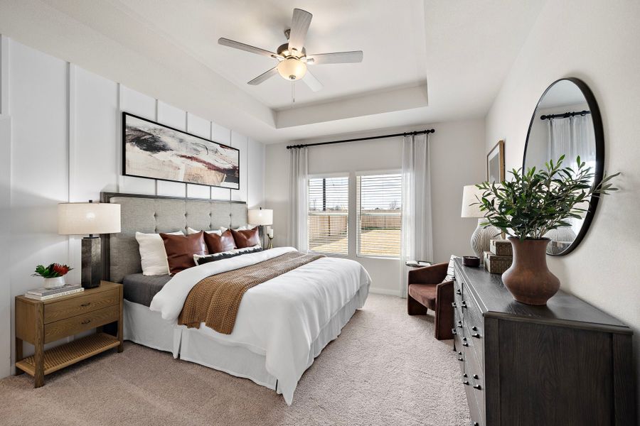 A bedroom with a large mirror.