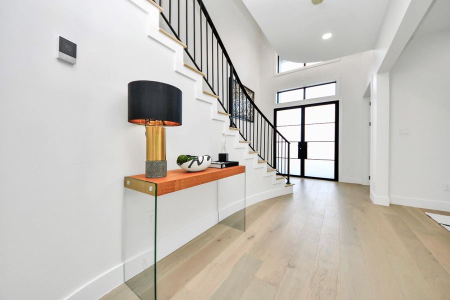 The grand foyer features generous proportions and a welcoming flow, setting the stage for the home’s luxurious design.