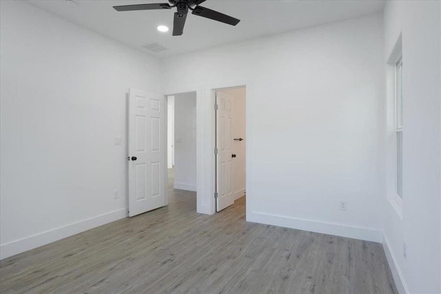 Spare room featuring light hardwood / wood-style floors and ceiling fan