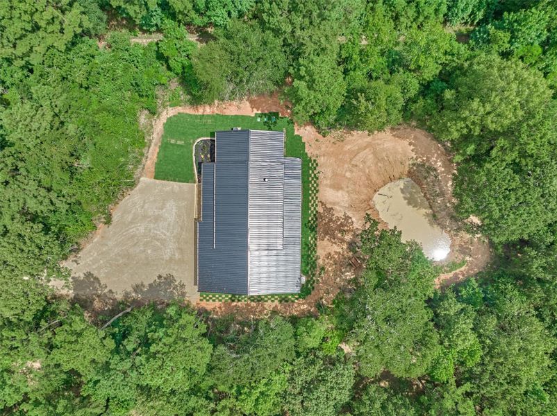 You'll find ample parking for guests or RVs along with a beautifully maintained green space and landscaping and your own private pond; offering the perfect blend of functionality and natural beauty