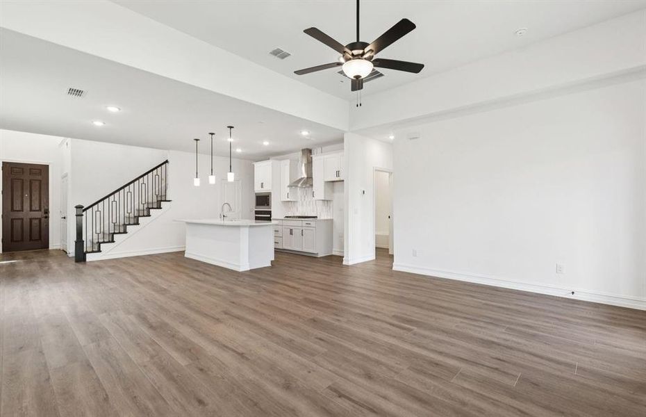 Open concept gathering room creating a spacious and inviting atmosphere   *Real home pictured