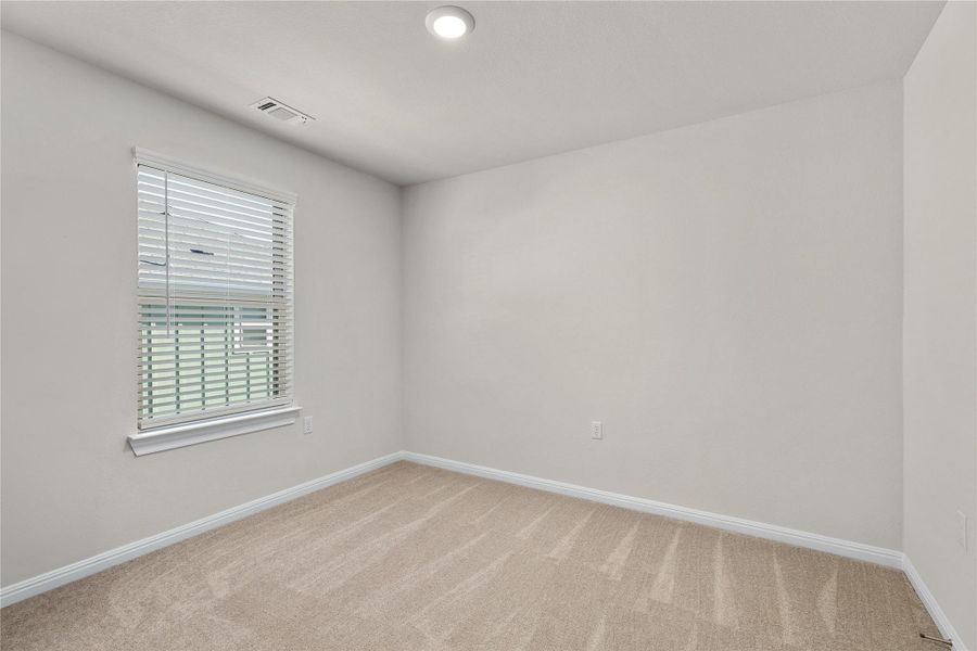 Unfurnished room with light colored carpet and recessed lighting