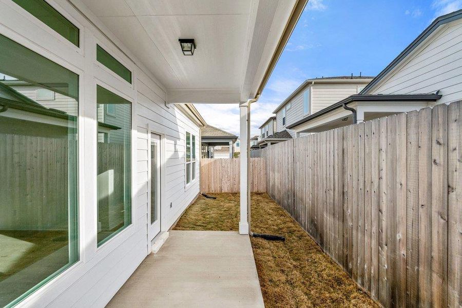 Fenced backyard with a patio