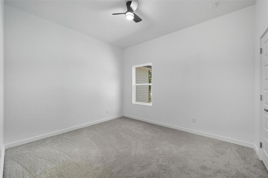 Spare room featuring light carpet and ceiling fan Spare room featuring light carpet and ceiling fan