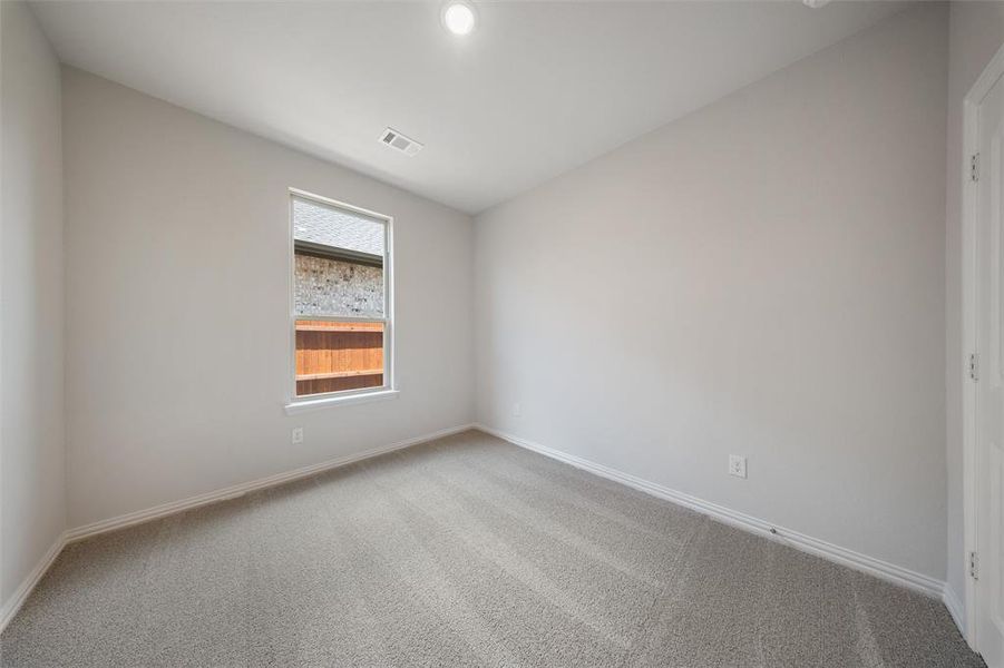 Carpeted spare room with baseboards