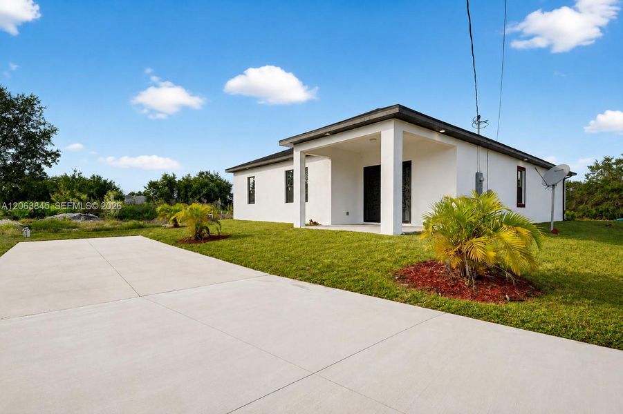Front exterior of a new home in , Lehigh Acres, FL, highlighting curb appeal (Image 20).