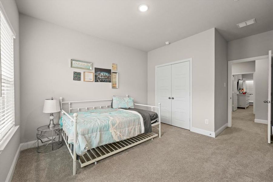 Bedroom with carpet flooring and a closet