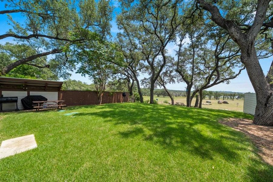 The spacious backyard is framed by mature shade trees and open green space, offering endless possibilities for entertaining, outdoor games, or simply enjoying the tranquil surroundings. The spacious backyard is framed by mature shade trees and open green space, offering endless possibilities for entertaining, outdoor games, or simply enjoying the tranquil surroundings.