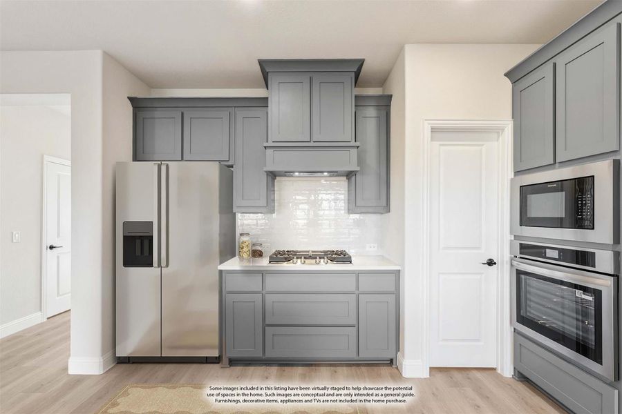 Kitchen with gray shaker cabinets, stainless steel appliances, gas cooktop, and white subway tile backsplash Kitchen with gray shaker cabinets, stainless steel appliances, gas cooktop, and white subway tile backsplash