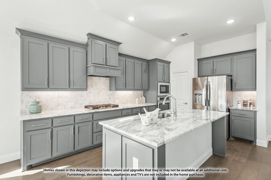 Kitchen with gray cabinets, marble countertops, center island with sink, and stainless steel appliances on hardwood floors Kitchen with gray cabinets, marble countertops, center island with sink, and stainless steel appliances on hardwood floors