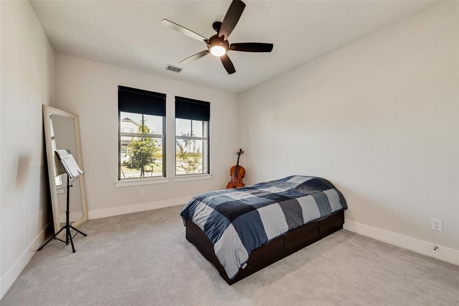 Bedroom with carpet flooring and a ceiling fan
