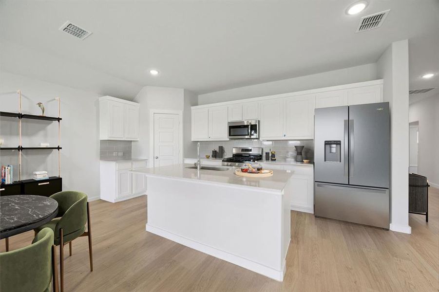 Kitchen in the Hadley home plan by Trophy Signature Homes – REPRESENTATIVE PHOTO
