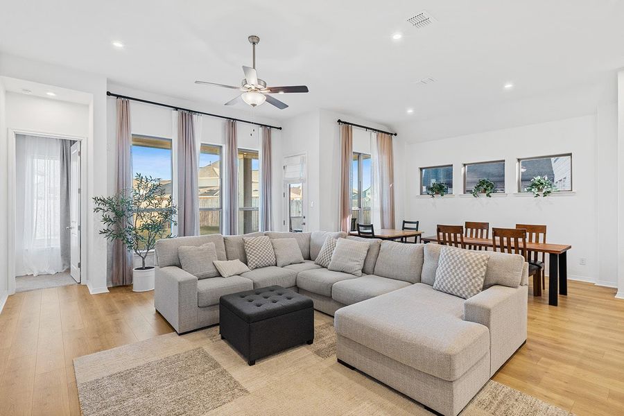 Living area featuring recessed lighting, light wood-style flooring, and a ceiling fan