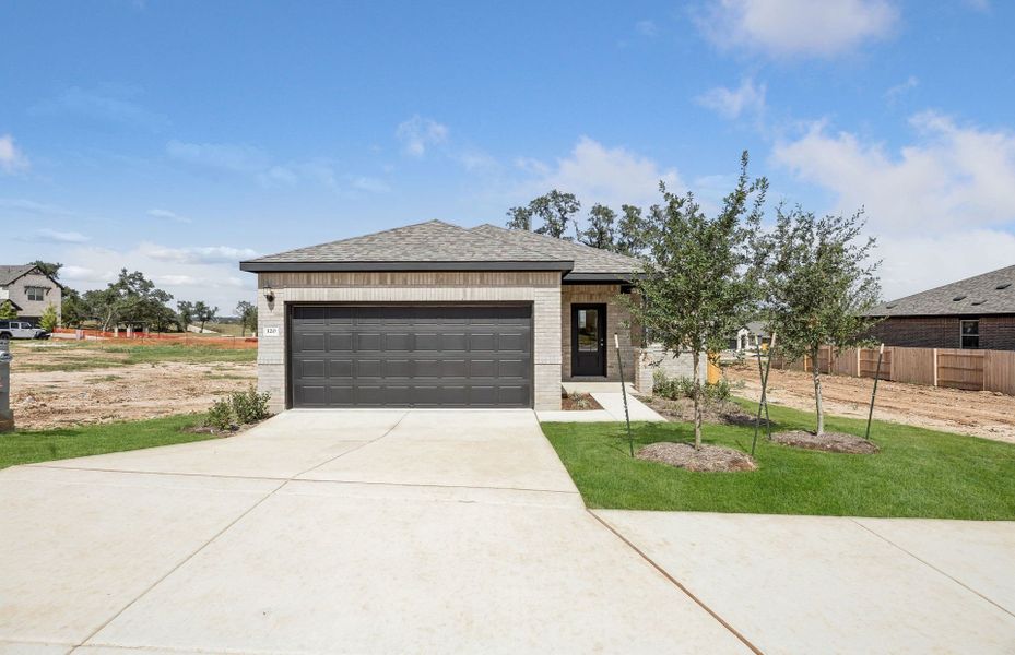 Front exterior of a new home in La Cima, San Marcos, TX, highlighting curb appeal (Image 19).