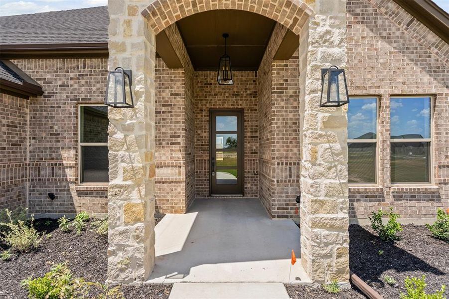 Entrance to property featuring brick siding Entrance to property featuring brick siding