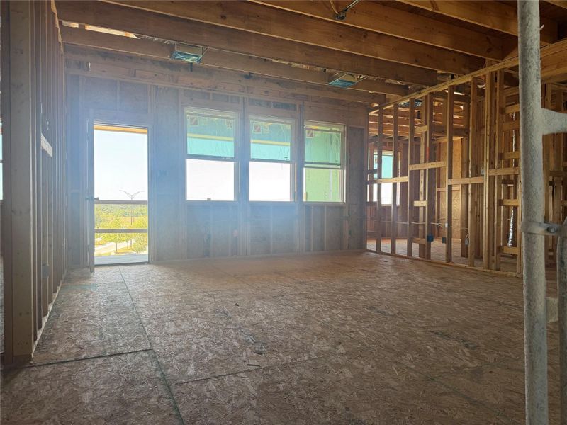 Exposed wood framing and subflooring define this upper-level room under construction.