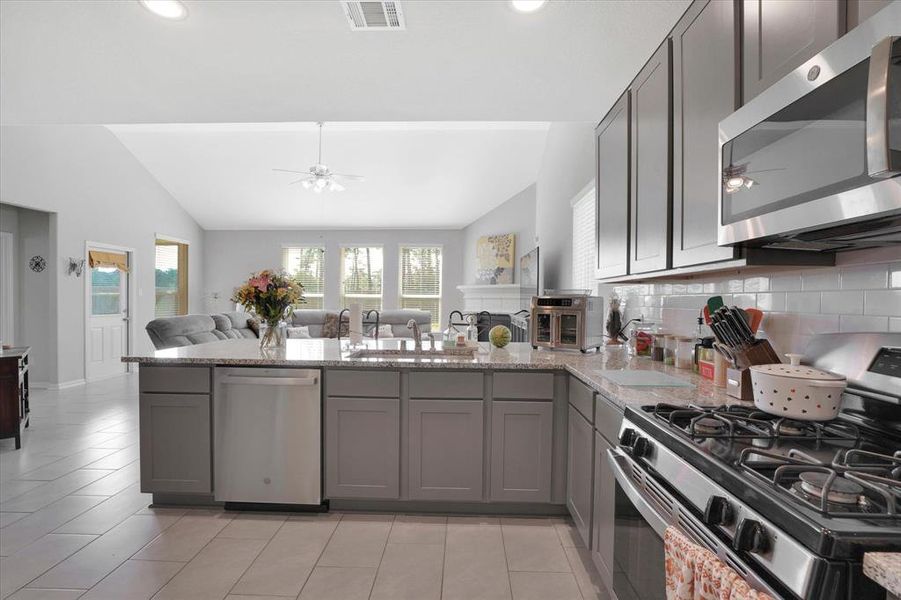 Expansive, modern kitchen with ample counter space and granite counters