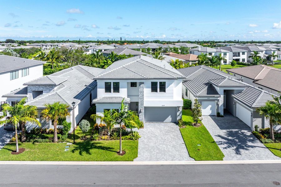 Front exterior of a new home in Lotus Edge, Boca Raton, FL, highlighting curb appeal (Image 26).