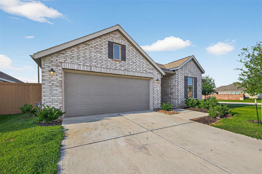 Front exterior of a new home in Sunterra, Katy, TX, highlighting curb appeal (Image 2). Front exterior of a new home in Sunterra, Katy, TX, highlighting curb appeal (Image 2).